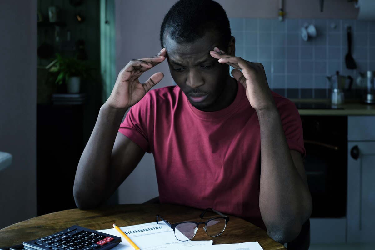 man looking at the paper bill