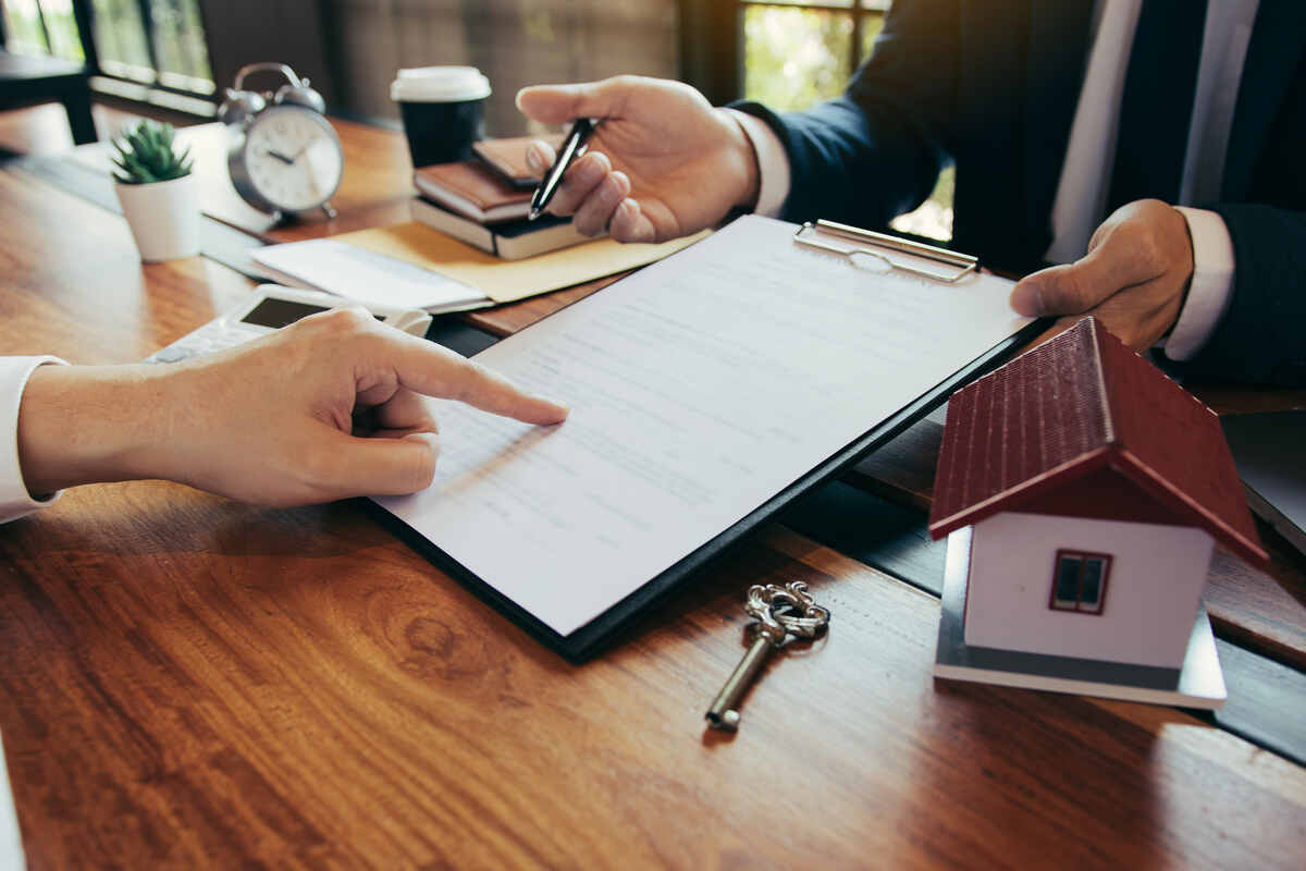 Real estate agent showing the place to sign a contract