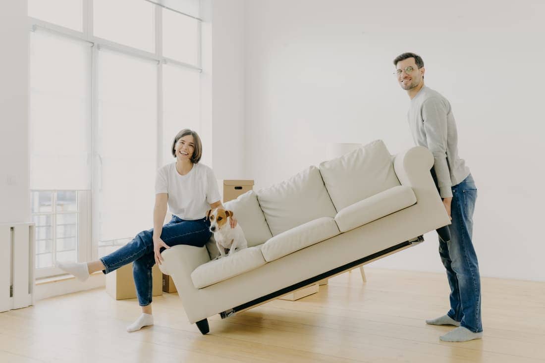 Husband And Wife Carry Sofa