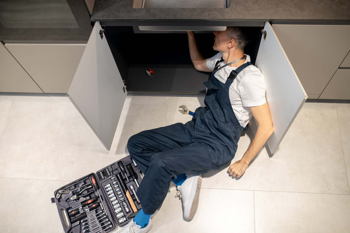 Man Repairing the Sink