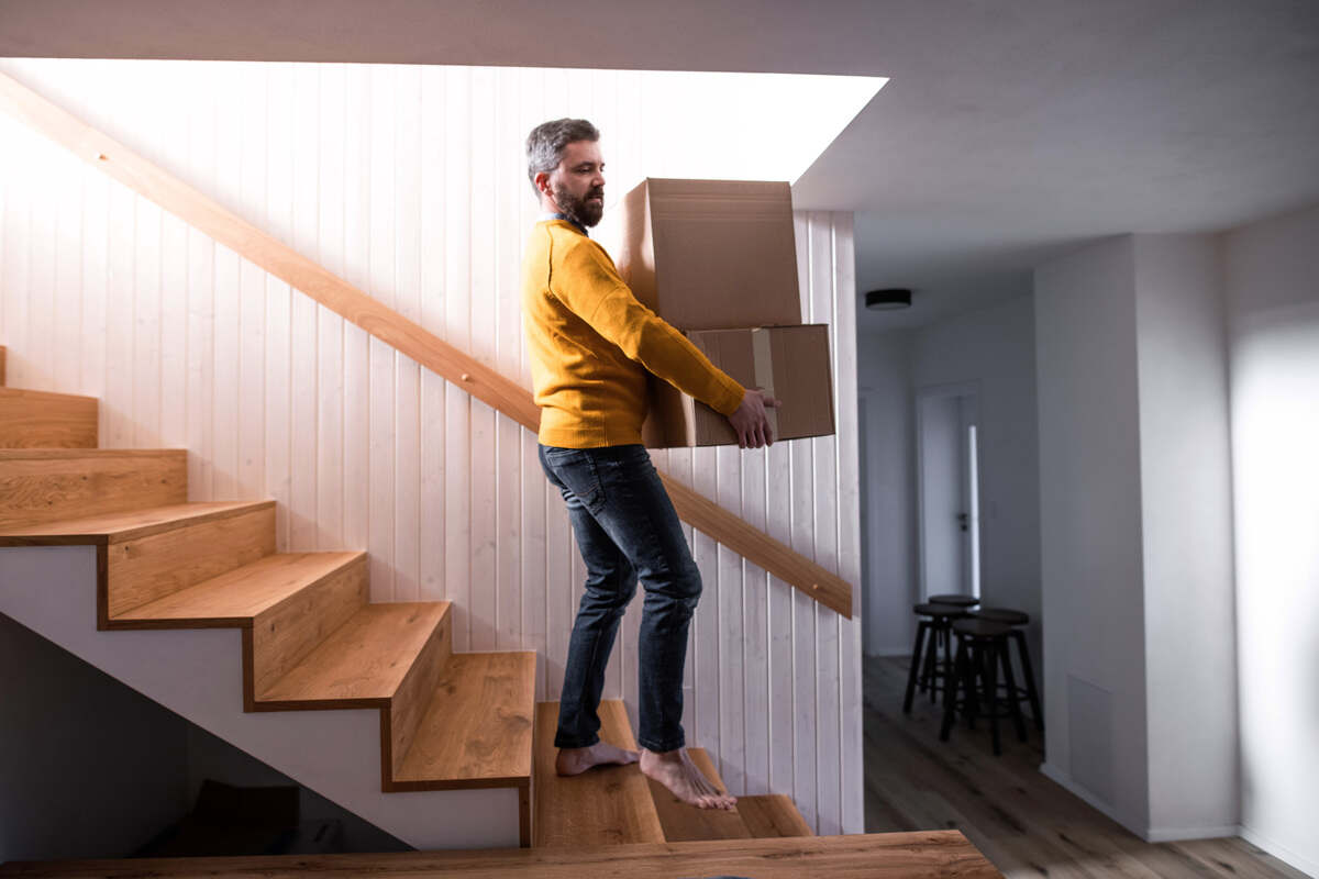 Man Walking Down Stairs In Mouse Moving Out