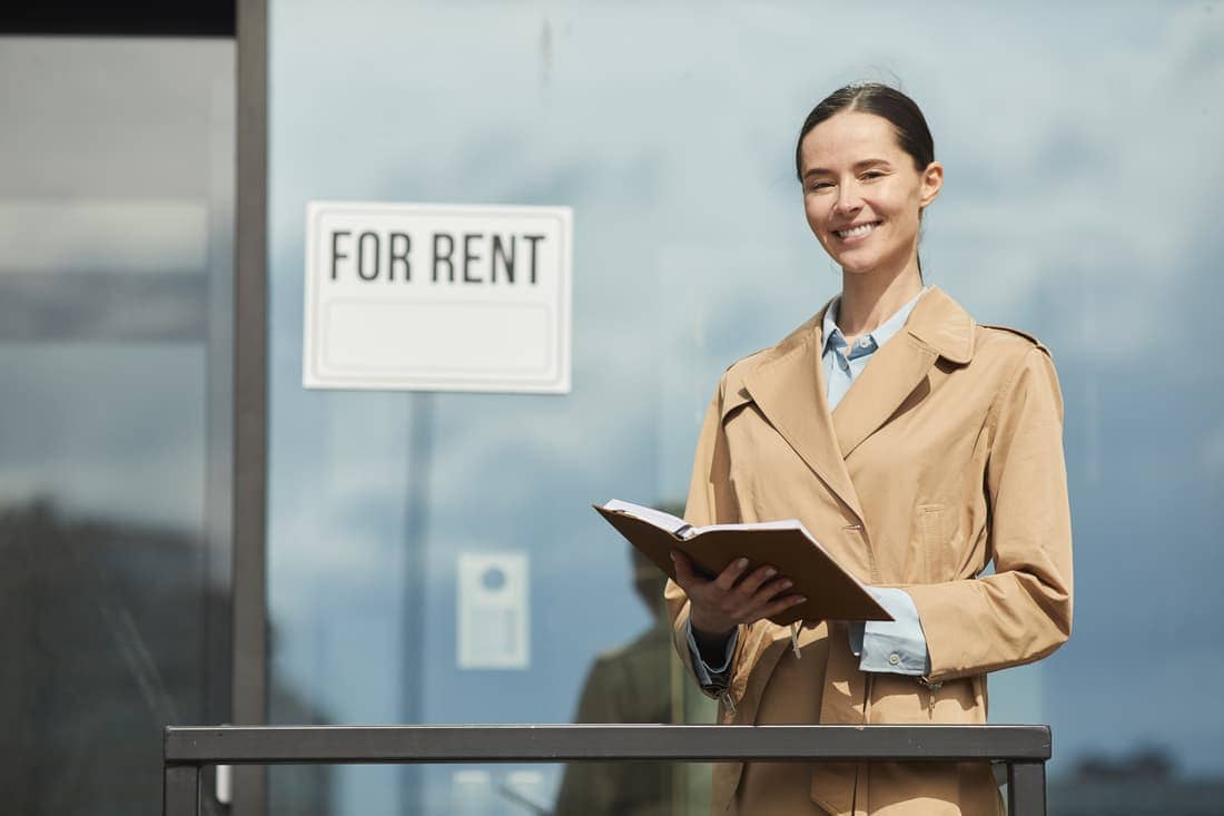 Smiling Young Woman Renting Office