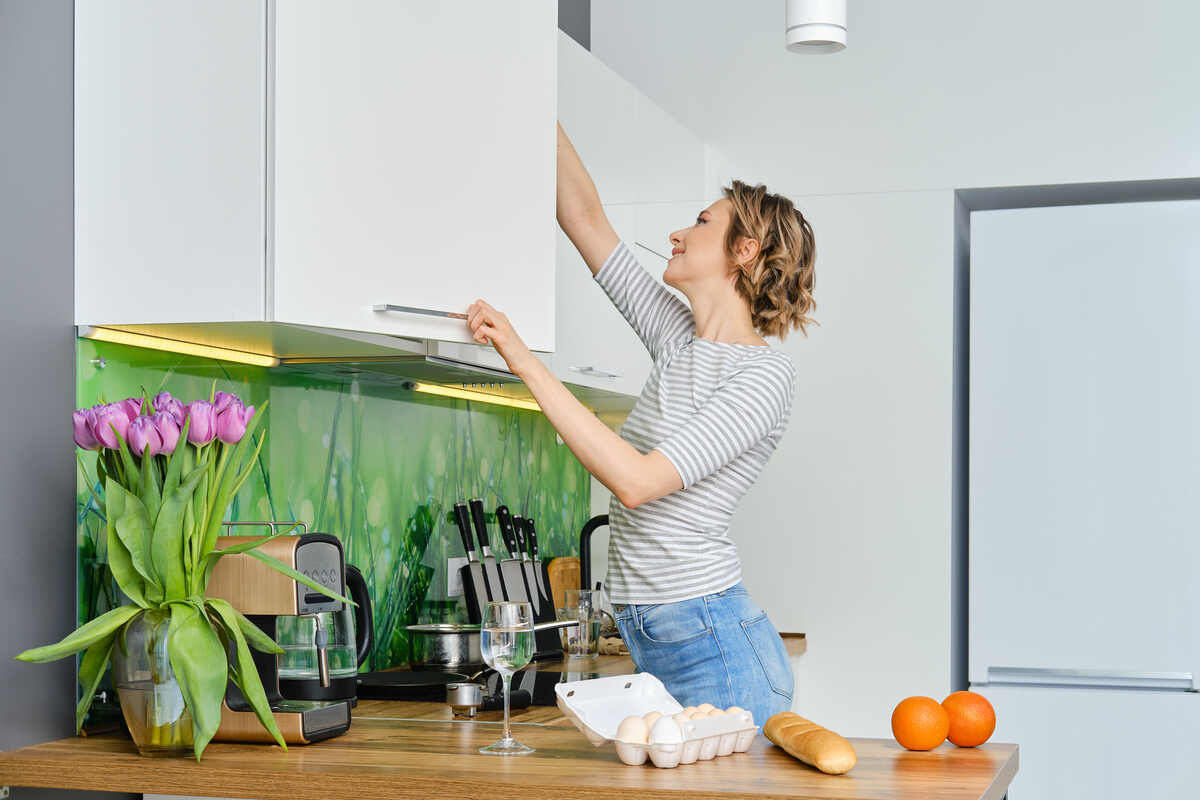 young-woman-organizing-kitchen